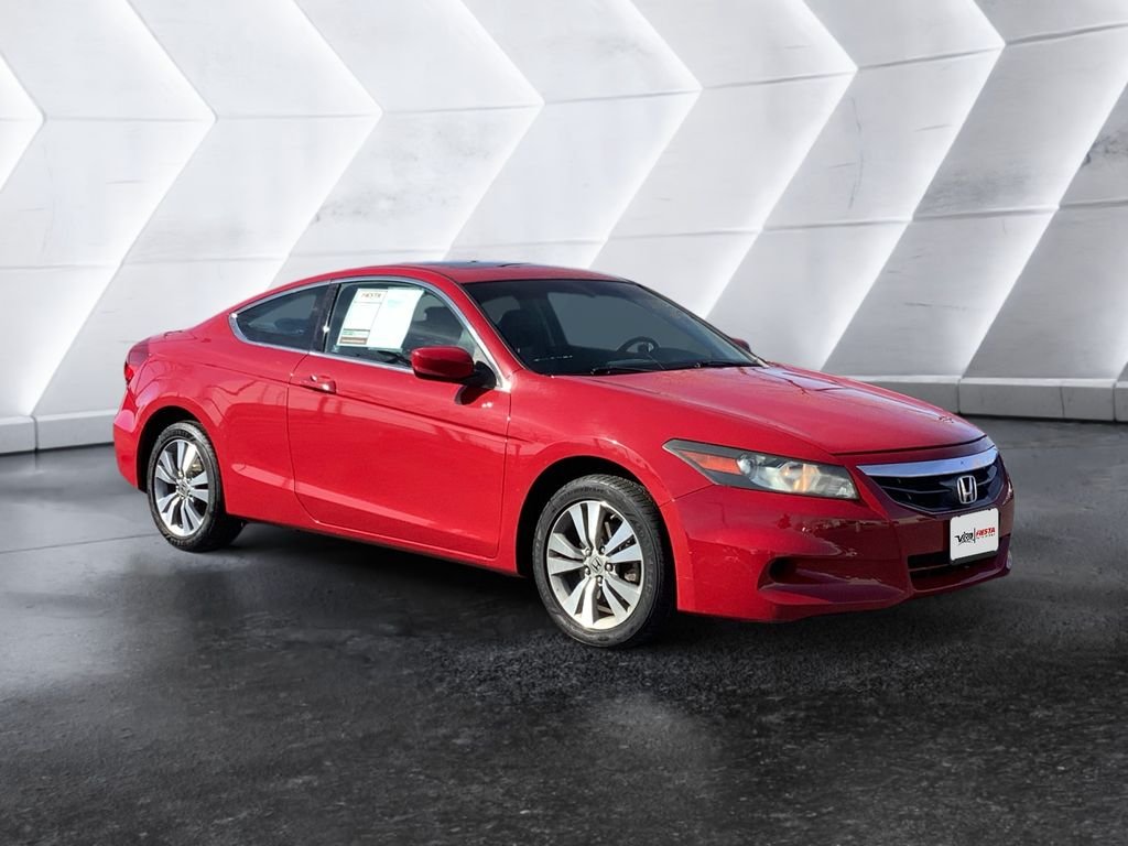 A red coupe in a dealership showroom